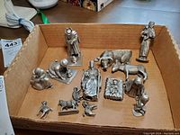 All nativity figurines arranged in a cardboard box showing the entire set.