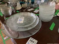 Four textured glass platters stacked, nine small textured glass bowls stacked, showing overall condition and style.