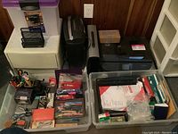 Overall lot photo showing HP printer, Omnitech shredder, plastic containers with various office supplies and papers