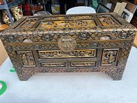 Full view of the Asian wooden decorative box with detailed carvings and brass lock.