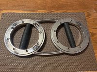 Photo of the Burn Machine cardio speed exercise device showing dual metal rings with rubber grips connected by a metal bar.