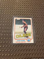 Front of the Jari Kurri hockey card showing the player in Oilers uniform, Oilers team name and logo, and card details including position and player name.