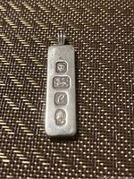 Front view of rectangular sterling silver pendant showing four hallmarks