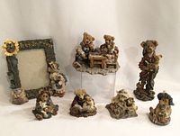 Full view of Boyd's Bears collection including 7 figurines and a photo frame, all resin collectibles in earth tone colors with detailed sculpting.