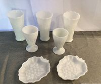 Full collection of 3 tall vases, 2 goblets, and 2 grape pattern dishes in white milk glass.