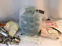 Photo of cupcake carrier, vintage icing tubes, and parchment triangles with some packaging shown
