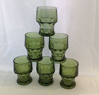 Six green textured Georgian glasses stacked, showing size and design