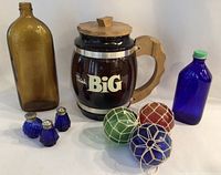 Lot contents including the cookie jar, glass bottles, salt and pepper shakers, and hanging glass balls all displayed together.