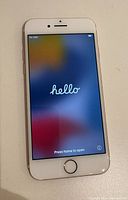 Front view of iPhone 7 displaying the welcome screen with 'hello' text, showing no cracks or screen damage.