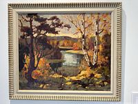 Full front view of framed oil painting showing autumn landscape with river and trees
