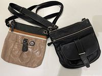 Both purses side by side on white background showing front views and straps