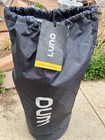 Black carrying bag with Luno label containing the vehicle air mattress.