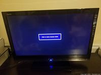 Sharp AQUOS 32-inch LCD TV powered on showing an error message 'Failed to acquire transmission 0303'.