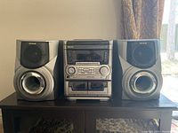 Full front view of Aiwa stereo system with speakers on each side.