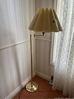 Full view of the metal floor lamp with the shade and the moveable arm, showing its height and condition.
