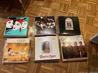 Six vinyl LP record covers shown, featuring artists such as The Kinks, Roberta Flack, and a Gold Record collection.