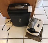 ShredSafe shredder and Pro-Shiatsu massager placed on tile floor, showing both items clearly