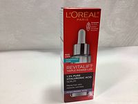 Front of the L'Oreal Paris Revitalift Triple Power LZR 1.5% Pure Hyaluronic Acid Serum packaging showing brand, product name, key ingredients and benefits.