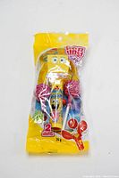 Full view of sealed Pop Up Trendy Friends SpongeBob candy toy with attached two lollipops in yellow packaging.