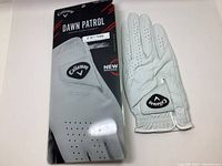 Front view of the golf glove with packaging showing the Callaway logo and Dawn Patrol branding.
