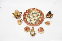 Overview of the entire Christmas miniature tea set showing the decorative plate, teapot, cups, plates, and figurines on a white background.