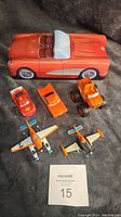 Overview of all toy vehicles including large Corvette tin, planes, and cars