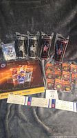 Lot includes unopened 2003-2004 mini puck pack, NHL star sticks sealed from 2007-2008, commemorative hockey annual book, and dated hockey tickets from 2006
