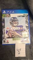 Front cover of Madden NFL 21 PS4 game case showing NFL player and game title.