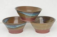 Three studio art pottery bowls stacked, showing outer glaze and shape.