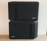 Front view of two BOSE 201 Series IV bookshelf speakers stacked, showing black grille covers and BOSE logos.