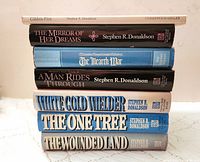 Stacked view of eight Stephen R. Donaldson fantasy books showing spines and some authorship and publisher details.