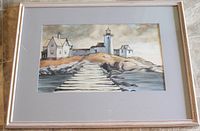 Framed view of the watercolour painting featuring the lighthouse and pier, showing full artwork and mat within the frame.