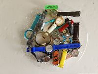 Top view of multiple vintage watches together showing different bands and watch faces.