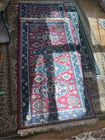 Photo showing two runners laid side by side on larger area rug, highlighting pattern and condition