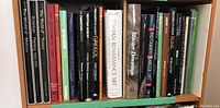 Shelf view of art and museum books, titles visible covering painting, drawing, and photography topics.