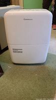 Front view of white Garrison dehumidifier showing clean plastic body with brand name.
