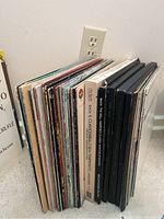 Photo showing a side view of approximately 34 upright classical music LPs, highlighting different spine colors and text.