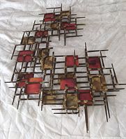 Full view of mid century modern brutalist metal wall sculpture showing overall geometric design and mixed metal materials.