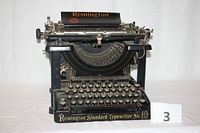 Front view of the Remington Standard Typewriter No. 10 showing the brand name, logo, serial number and the full keyboard layout with round cream keys.