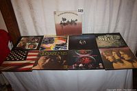 Overview of all nine LP covers laid out on fabric backdrop, including Beatles, Moody Blues, Sly & the Family Stone, The Doors, Iron Butterfly, The Association, Emerson Lake & Palmer and Blood, Sweat & Tears.