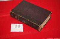 Closed leather bound book with some wear on the spine and edges.