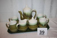 Full view of the entire set on green plastic tray with all pieces arranged