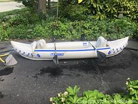 Inflated kayak outdoors with paddles installed