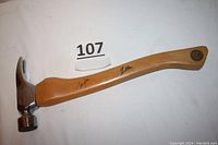 Full view of the hammer showing nickel plated head, straight claw, wooden handle with signatures, and logo on handle.