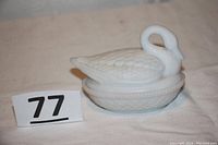 Side view of white satin finish glass swan trinket dish with lid on, showing detailed feather work and curved swan neck with no chips or cracks visible.