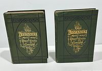 Two green hardcover volumes with gilt titles and decoration on the covers and spines, showing slight edge wear.