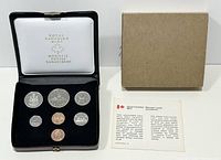 Photo of the 7 coin set in the original Royal Canadian Mint presentation box with outer cardboard box and small information card