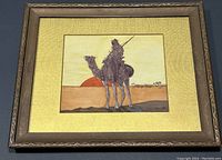 Framed watercolour painting showing camel in desert at sunset/sunrise with signed date May 1918.