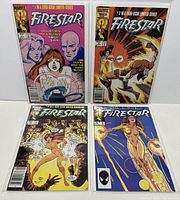 Four comics in bagged and boarded condition laid out showing front covers. Firestar titles clearly visible with vibrant colors and detailed comic art.