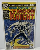 Front cover photo showing full comic book cover with Moon Knight character, title, and publication details. The comic is inside protective bag and board.